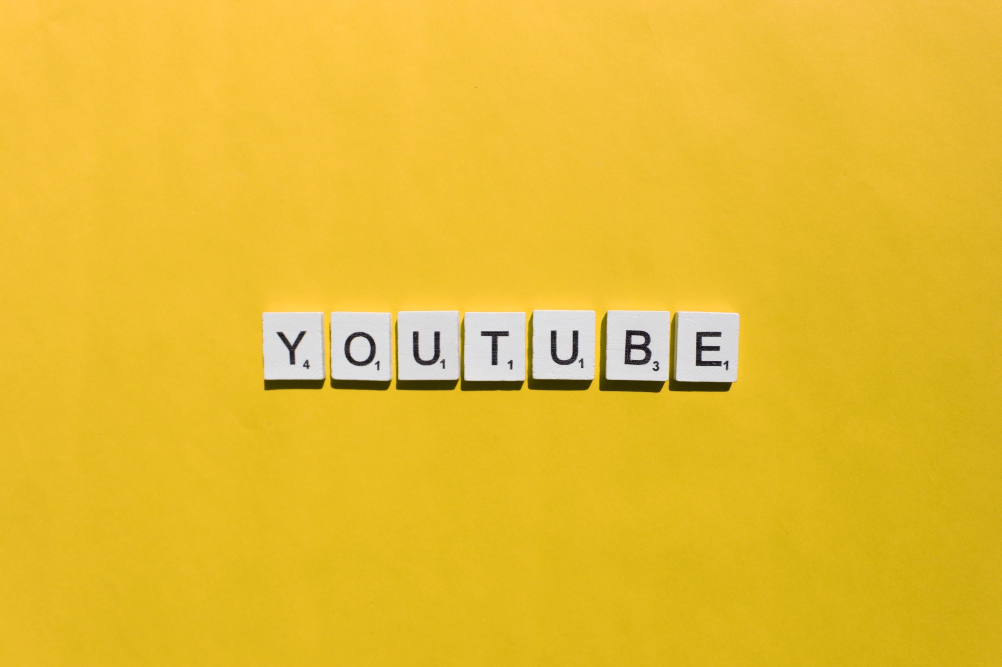 YouTube scrabble letters word on a yellow background